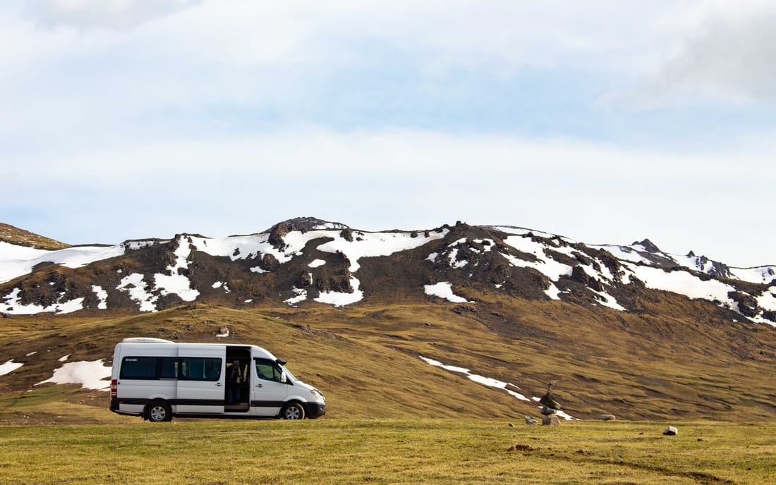 A minibus on a green mountain plateau